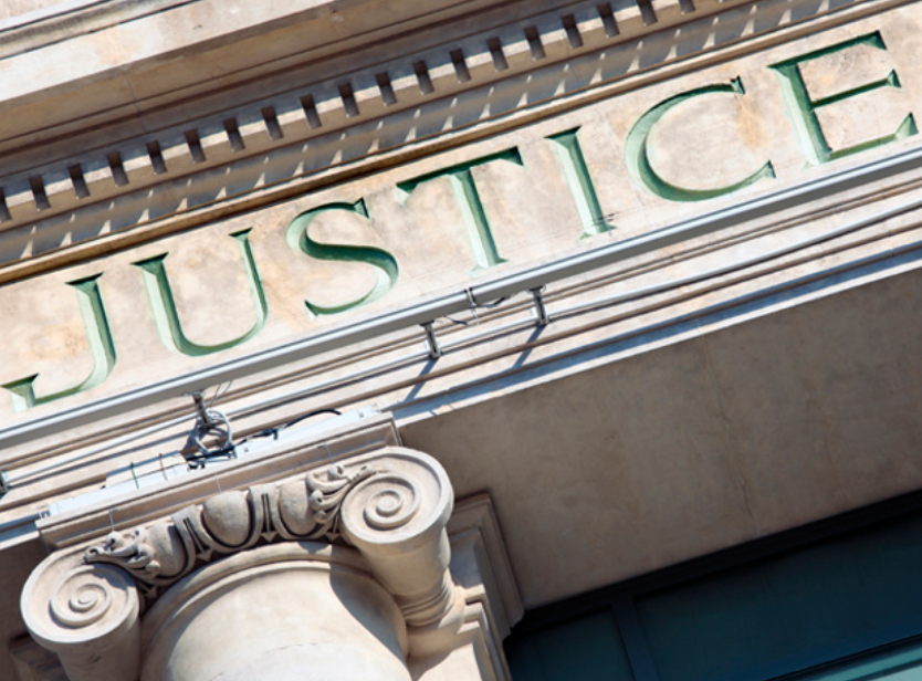 Justice sign on courthouse.